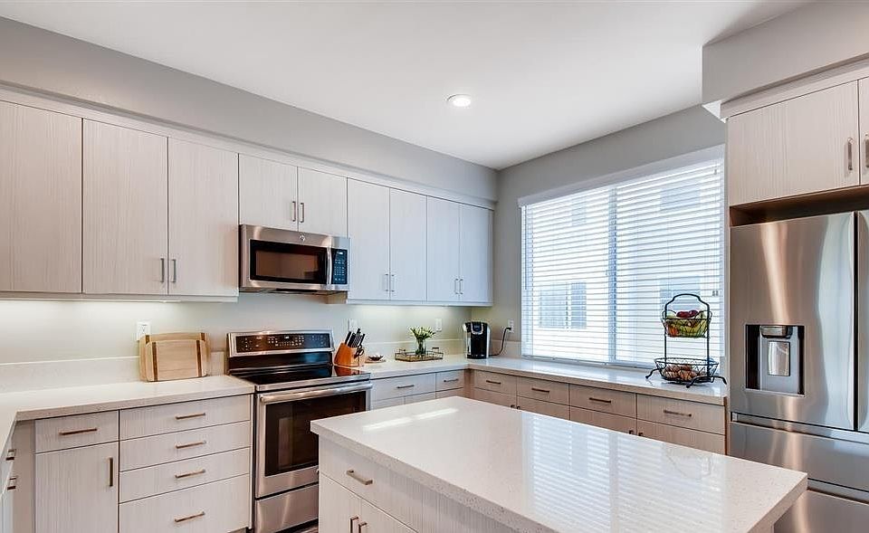 The kitchen is spacious with a prep island and plenty of cabinets for storage