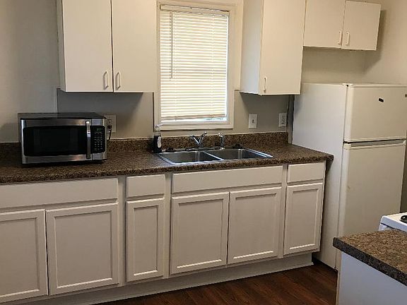 Kitchen with Refrigerator, Stove and Microwave. There is not a Dishwasher.