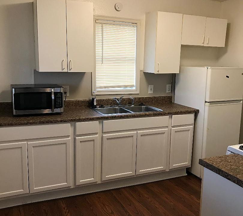 Kitchen with Refrigerator, Stove and Microwave. There is not a Dishwasher.