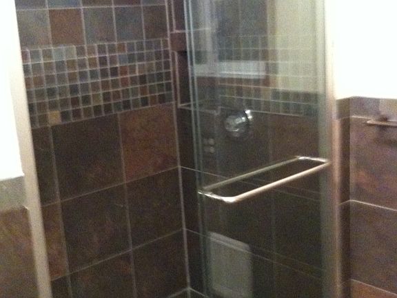 nice tiled shower room with glass sliding door