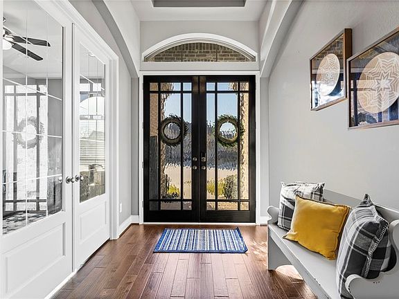 View of the beautiful front doors from inside the home with double doors leading to home office/study.