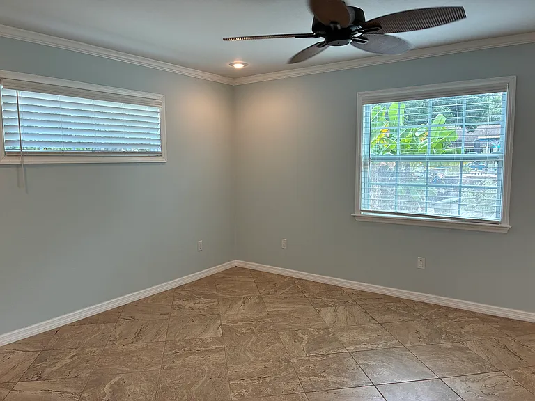 Primary bedroom overlooking yard and canal