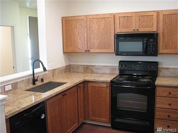 Remodeled kitchen with granite counters, new sink and faucet.