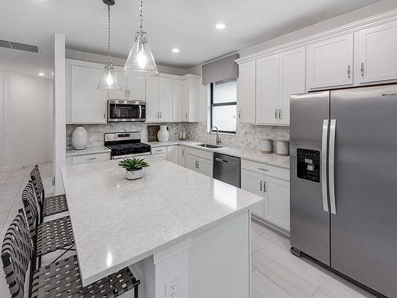 Kitchen with large center island and stainless steel appliances