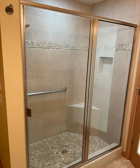 Step in Shower with upgraded tile finishes, and glass door