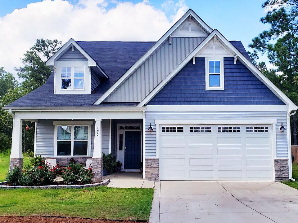 Front with covered porch and two car garage