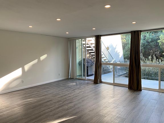 Living Room w/ Floor-to-Ceiling Windows and Private View