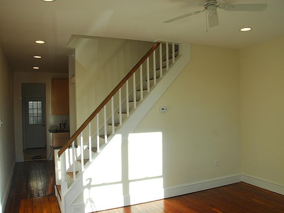 First floor looking from living room toward kitchen, newly refinished hardwood floors, recessed lighting