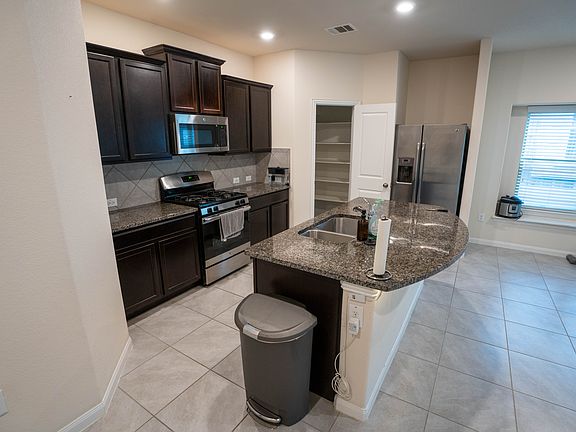 Kitchen and pantry. New microwave is on the way. Gas stove, oven, refrigerator, and dishwasher are available.
