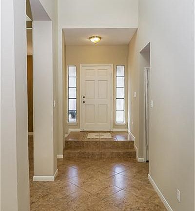 Grand entrance with vaulted ceilings and fresh paint