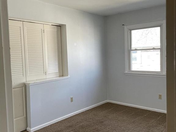 1st Bedroom/Office view from hallway with doors to living room closed.