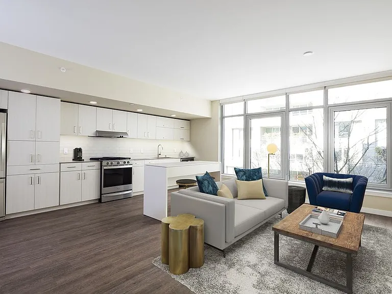 Scheme I kitchen, dining, and living area with hard surface flooring.