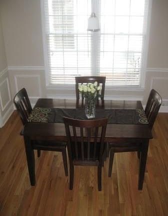 Formal dining room w/ wainscoting & crown moldings