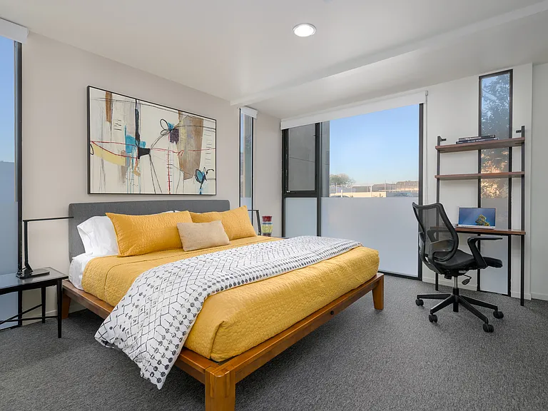 Primary bedroom with king bed, work space and large closet
