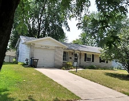 White brick ranch with attached garage