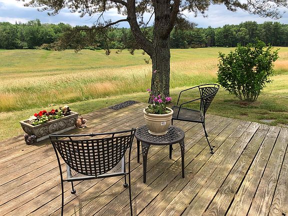 Outdoor deck overlooking rolling fields of hay.