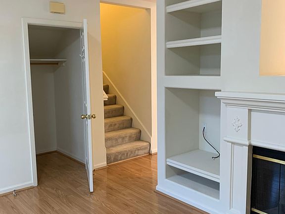 Living room closet and stairwell next to living room