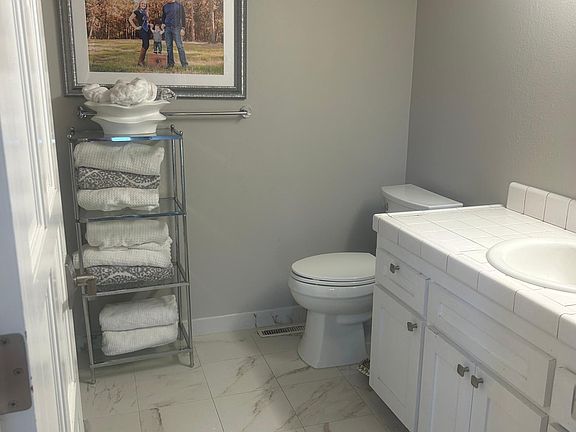 second bathroom with full tub and dual sinks