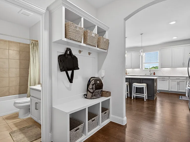 Built-in mudroom bench with cubby storage and coat hooks