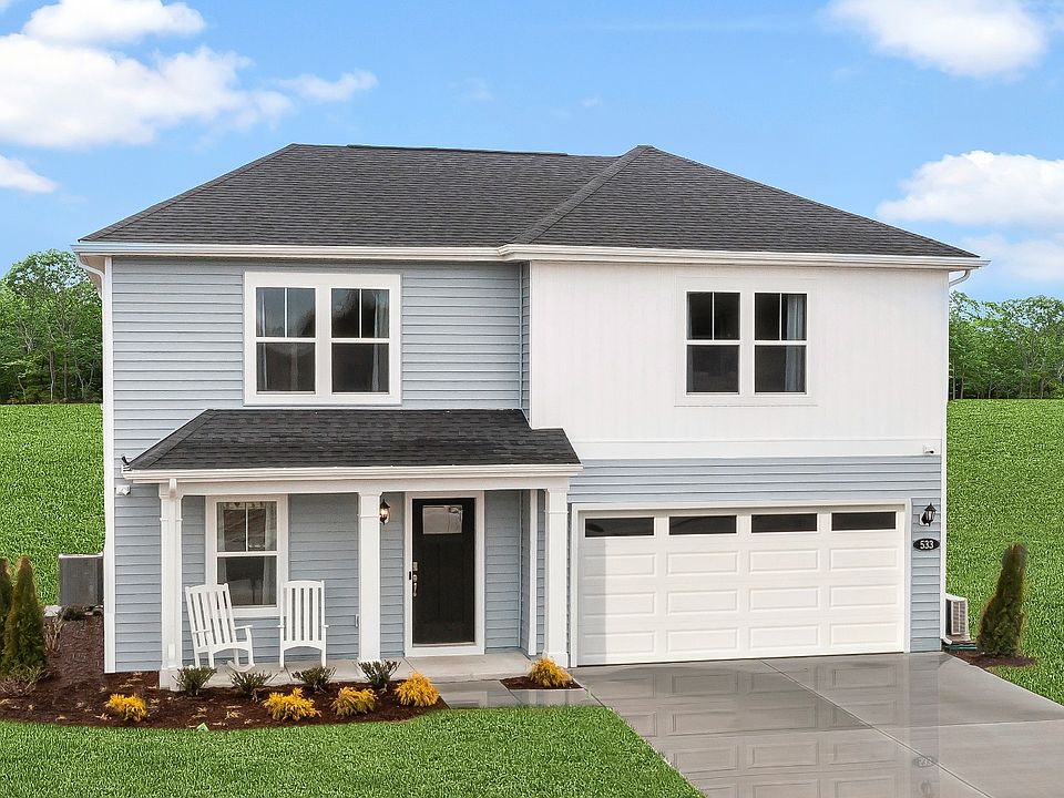 Exterior front with covered porch in a DRB Homes Whitehall model home at The Village of College Par
