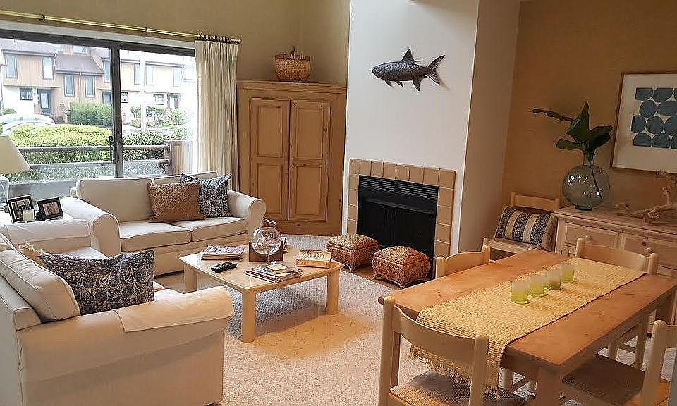 Living room with wood burning fireplace and sliders to deck
