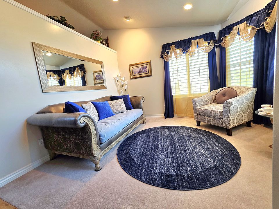 This is the main entry living area. This two bedroom place comes furnished and includes 2 bedrooms upstairs, 3 living sitting areas, one main kitchen, dinning table, and laundry __