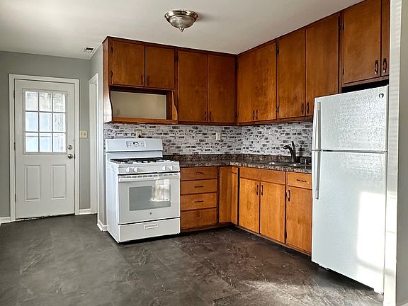 Kitchen comes with a fridge/freezer, gas range, and pantry around the corner.