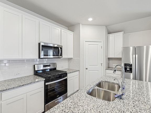 Cook a delicious meal in the beautiful kitchen.