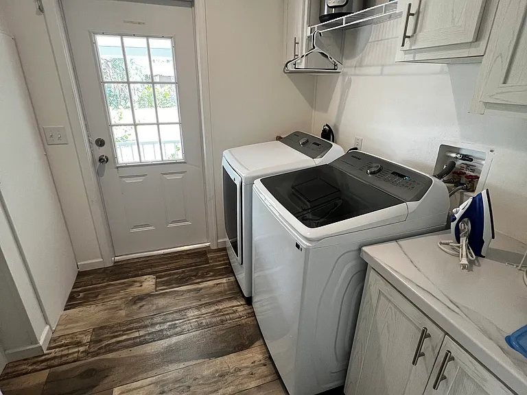 Laundry room with plenty of storage space. Looking at side door.
