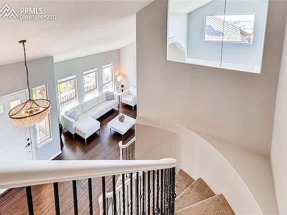 Gorgeous entryway with vaulted ceiling and spiral staircase.