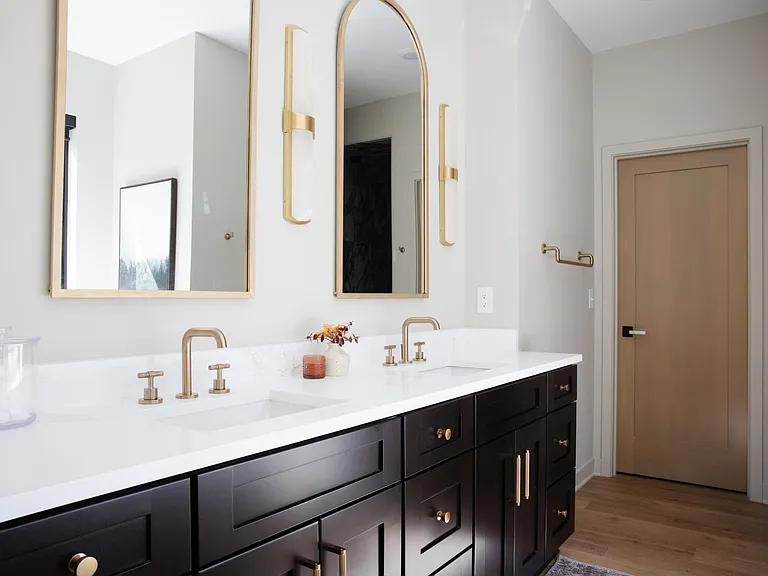 Primary bathroom with double vanity and large walk in closet.