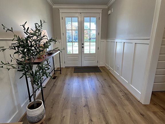 Foyer with wainscoting and crown molding