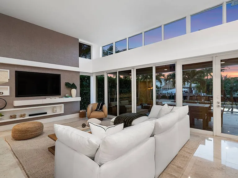 Comfortable living area with expansive windows, a modern fireplace, and expansive seating for memorable moments together.