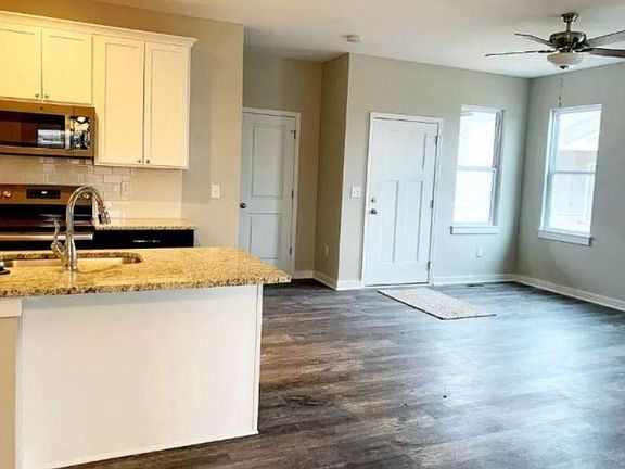 Large open floor plan with wood-look luxury vinyl hardwood floors & 2" faux wood mini blinds throughout! & ceiling fans.