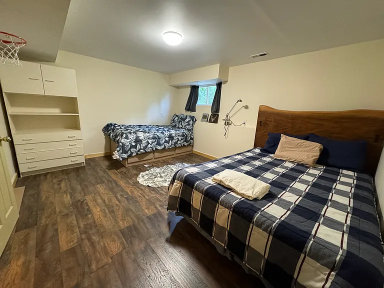 Bedroom 3 in basement - spacious with queen and twin beds. Closet space in addition to the wardrobe.