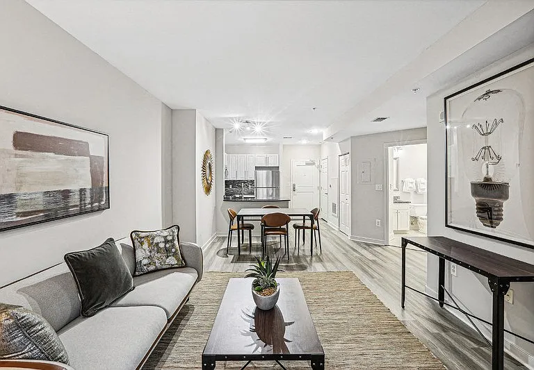 Full View of Living and Dining Area with Entrance to Bathroom