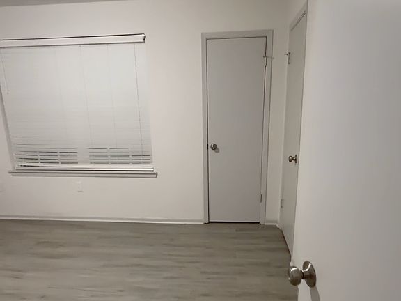 Comfortable bedroom with updated flooring, great lighting, and a large closet for storage and organization.