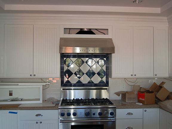 Beautiful kitchen with white wainscoting cabinets, stainless steel, 