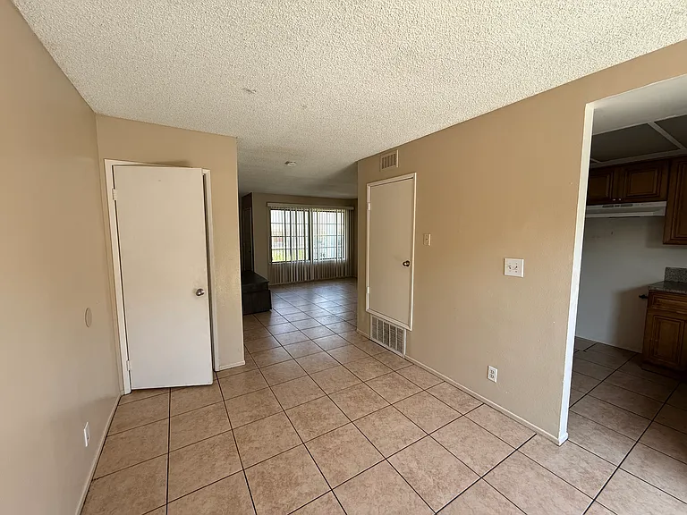 Brightly lit dining area next to kitchen