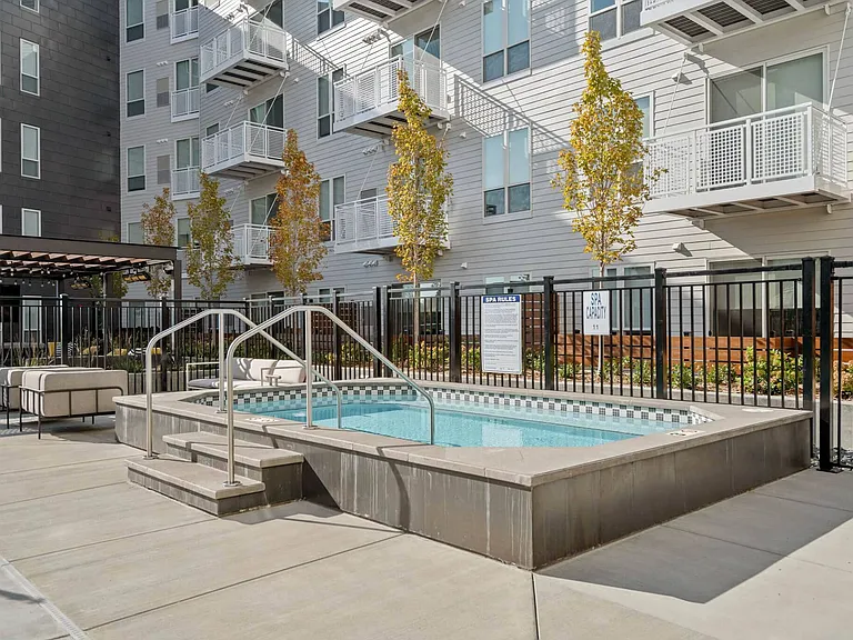 Take a dip in the hot tub, part of our rooftop amenity deck at The Hallon Luxury Apartments in Hopkins MN