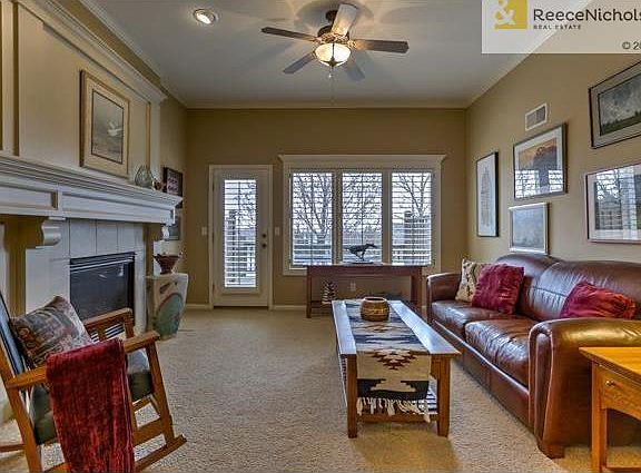 Great room has beautiful gas fireplace. Door opens to deck.