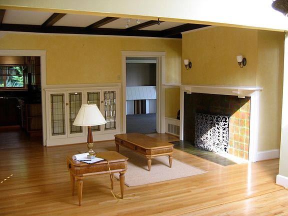 Main Living Room showing built in leaded glass cabinet and fireplace