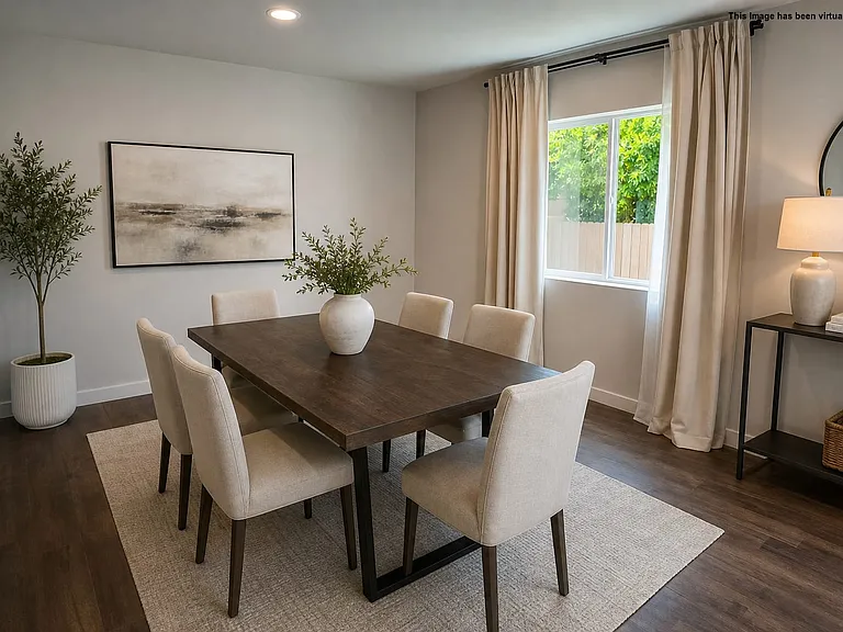 Dining area with plenty of light through large windows, virtually staged.