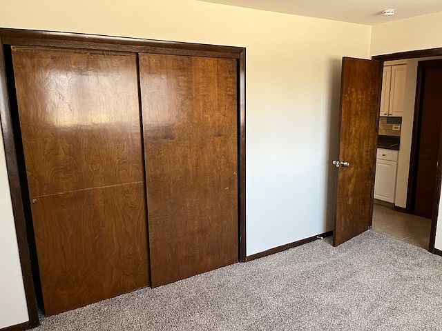 Large bedroom with new carpeting and ample closet space