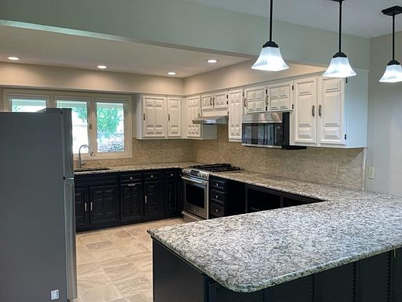 Granite counters, neutral tile floors, stove/oven/vent hood, dishwasher and new stainless refrigerator & microwave.