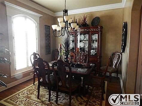 Dining room features lovely light fixture and a grand view of th