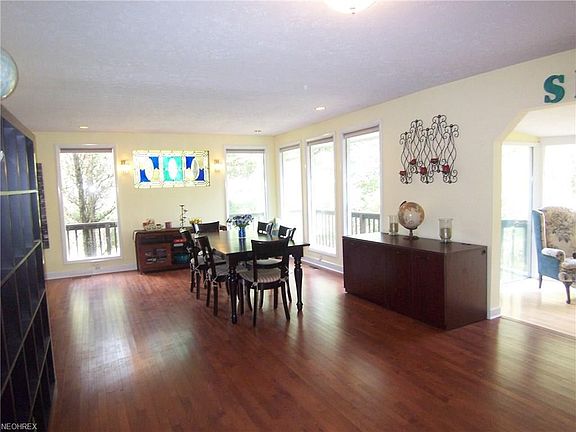Dining room is approx. 21 x 26 with hardwood floors, access to the deck and smaller sunroom.