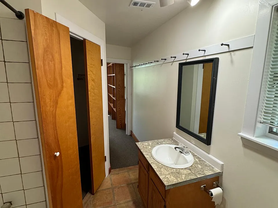 Bathroom with full bath and walk-in closet