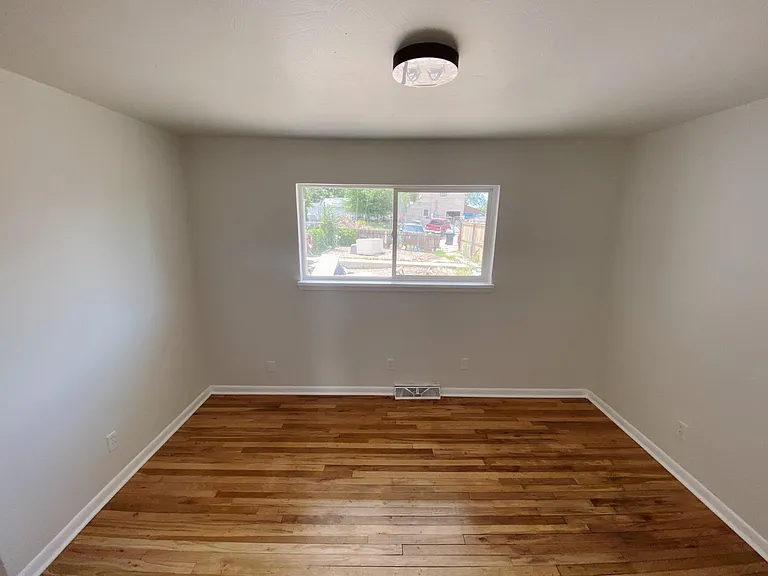 First bedroom with a view of the backyard (landscaping coming in July). Approximately 9x13'
