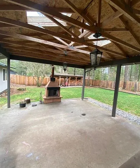 Backyard and patio with fireplace.
